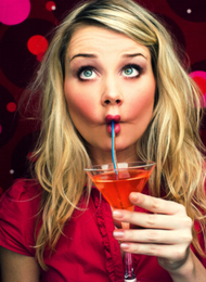 Woman from a hen party Drinking A Cocktail Pulling A Face
