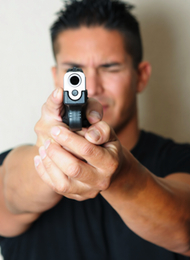 Man Shooting A Pistol at the camera