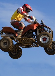 Quad Bike & Rider In Mid Air With A Sky As Background