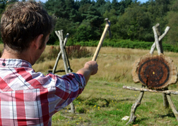 Man From a Stag Party taking aim whilst Axe Throwing