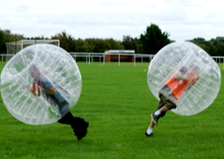 stag party playing Bubble Football in mid hit