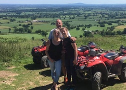 Father and daughters quad biking in North Wales