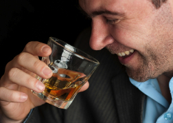 Man drinking a dram of whiskey