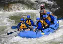 stag party White Water Rafting in a blue raft