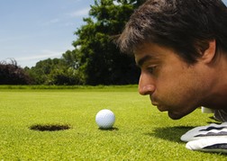 Golfer Blowing Ball In To Hole