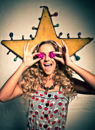 Lady from a hen party being silly and holding Shot Glass To Her Eyes
