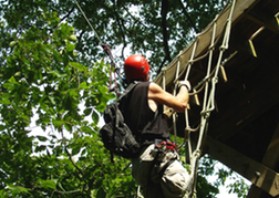 Man Taking Part In An Assault Course High Ropes