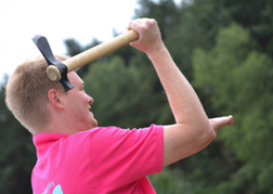 Man From a Stag Party taking aim whilst Axe Throwing