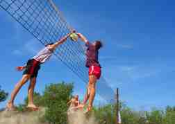 Beach Volleyball 2 men in the air getting air
