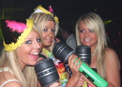 Girls pretending to sing on a hen weekend in Blackpool