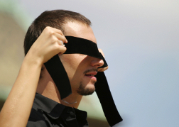 Man having a blindfold put on for blindfold driving