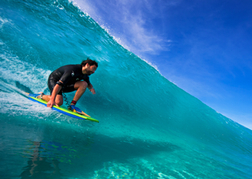 Catching a wave whilst Surfing clear sea