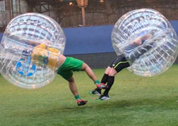 stag party playing Bubble Football both hitting and knocking each other over