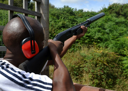 man taking part in Clay Pigeon Shooting whilst on a stag do