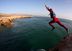 Person Jumping From Cliff Edge - Coasteering Newquay