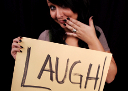 Lady With A Sign With Laugh Written On It