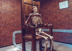 Skeleton on a chair in an escape room in Riga