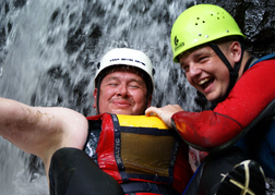 Groom from a stag party getting a dunking whilst Gorge Scrambling