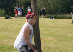 man attempting to toss the caber