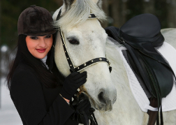 Lady with a horse in the snow