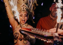 Hostess holding a limbo bar at Revolucion de cuba