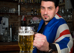 Bar Man in Union Jack Flag Giving you a beer