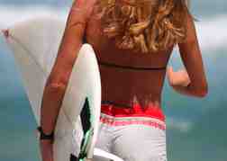 Lady Carrying A Surf Board