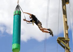 Man jumping on a high rope course Tarzan Time in Bristol on a stag weekend