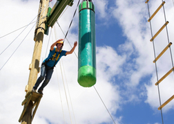 Man jumping on a high rope course Tarzan Time in Bristol on a stag weekend