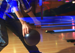 Man playing Ten Pin Bowling from a stag party