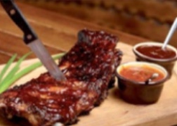 A meal of ribs with dips