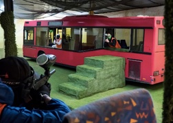 indoor Paintball game shooting at a stag party on a red bus