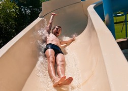 Man On a stag do going down a Waterpark Slide