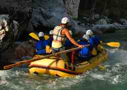 a group White Water Rafting through a gorge