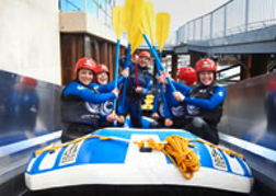 group going White Water Rafting pit their Oars in the Air on their weekend