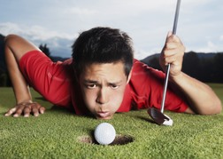 Golfer Blowing Ball In To Hole