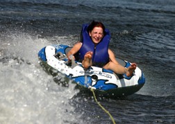 Hen form a hen party On A Doughnut being pulled along by a speedboat