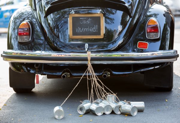 Black Beetle car with just married sign on the back with cans