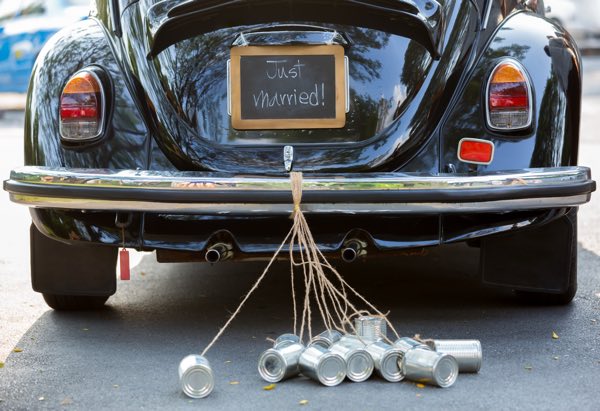 Black Beetle car with just married sign on the back with cans 