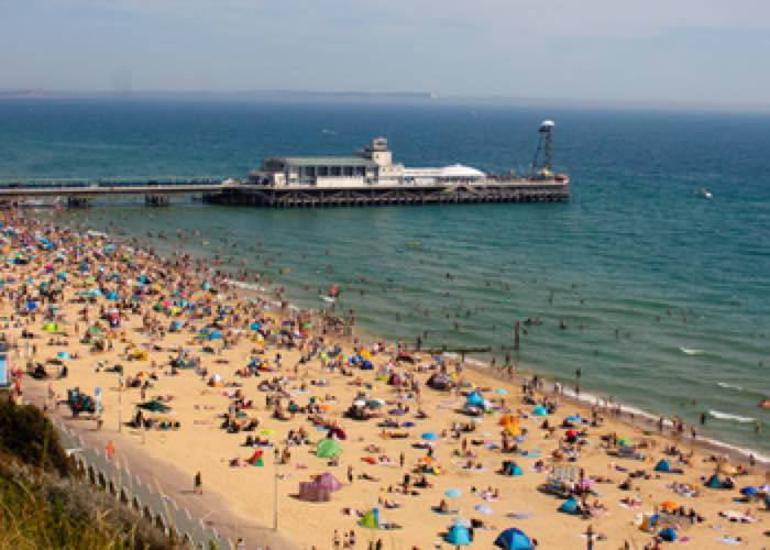 A birds eye view of busy Bournemouth Beach and Pier