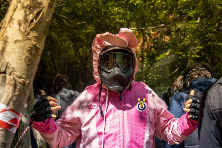 man on stag do dressed up as a pink bunny playing paintball
