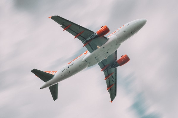 Easyjet plane flying over head just seeing the white under carriage and some orange from the logo