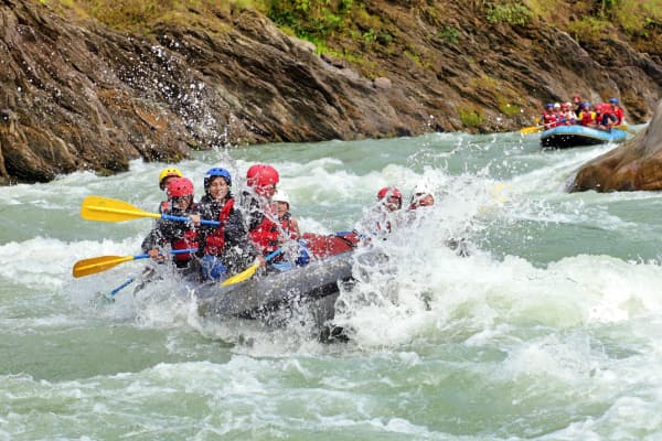 2 rafts with stag parties coming down the river in the highlands of Scotland close to Edinburgh